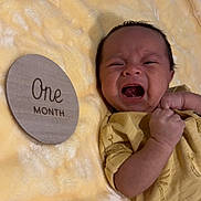 Aram joined the competition — help win amazing prizes! baby, newborn, crying, infant, yellow_blanket, wooden_sign, one_month, clenched_fist, lying_down, soft_texture, milestone, closeup, person, face, expression, cute, indoors, wearing_clothes, skin, small