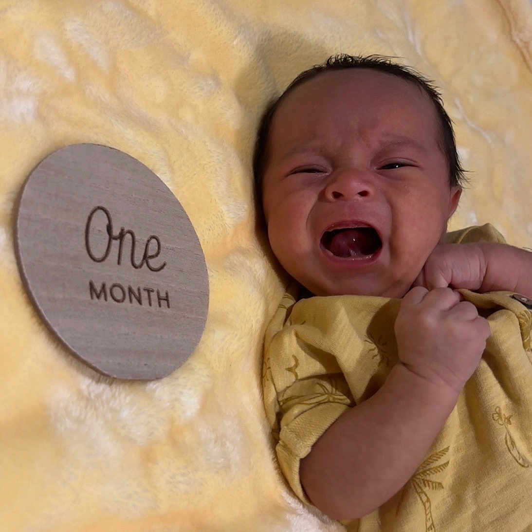 Aram joined the competition — help win amazing prizes! baby, clenched_fist, closeup, crying, cute, expression, face, indoors, infant, lying_down, milestone, newborn, one_month, person, skin, small, soft_texture, wearing_clothes, wooden_sign, yellow_blanket