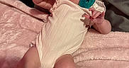Oakley is registered to the contest to win money with this photo: baby, infant, child, portrait, lying_down, pacifier, pink_blanket, onesie, bed, indoor, face, eyes, hand_gesture, smiling, baby_clothing, soft_blanket, nursery, close_up, photography, adorable