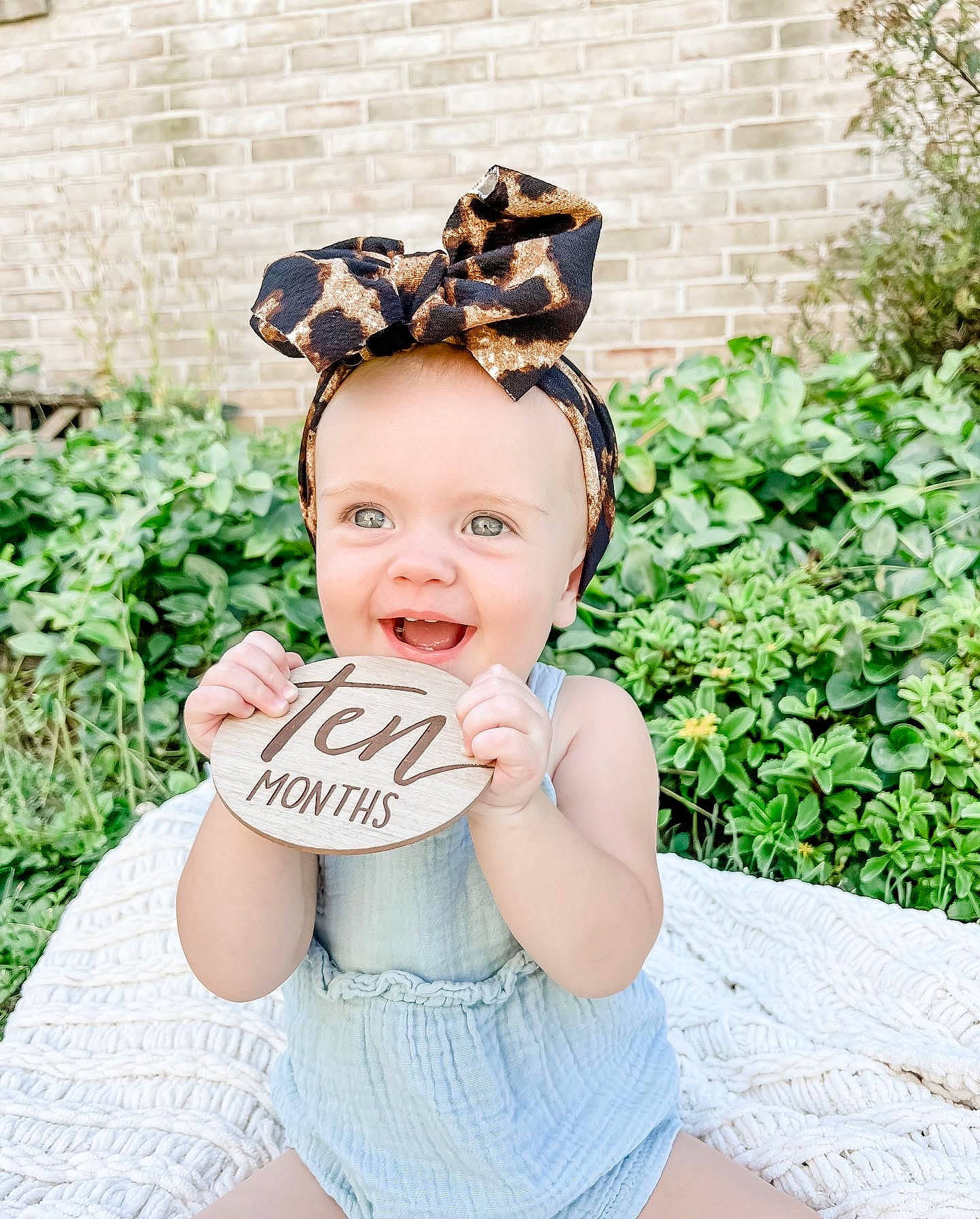 Gracelynn joined the competition — help win amazing prizes! baby, baby_toddler_clothing, child, cool, eye, fashion_accessory, grass, hair, hair_accessory, happy, head, headband, headgear, headpiece, jewellery, pattern, person, plant, sitting, smile