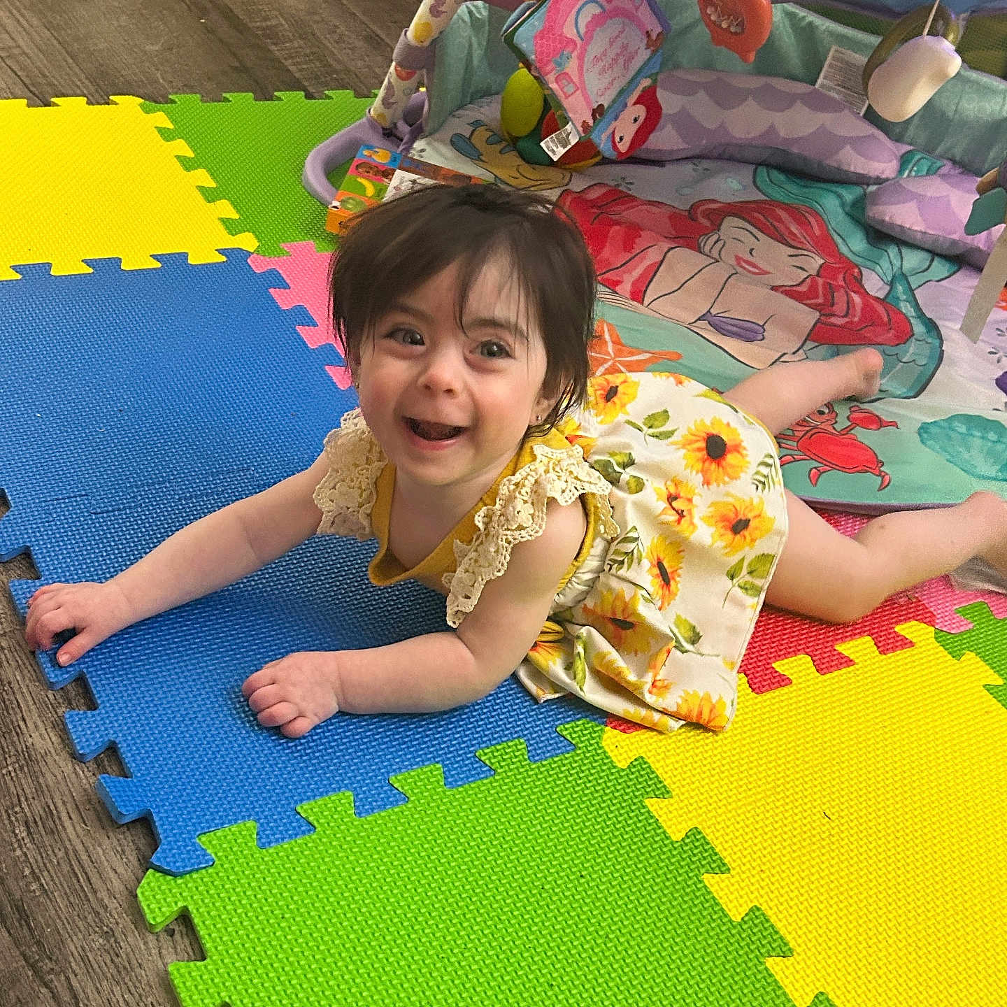 Lilith Azalea joined the competition — help win amazing prizes! baby, bright, child, colorful, crawling, cute, floor, foam_mat, fun, happy, home, indoor, person, play_gym, playtime, smiling, sunflower_dress, toddler, toys, young_child