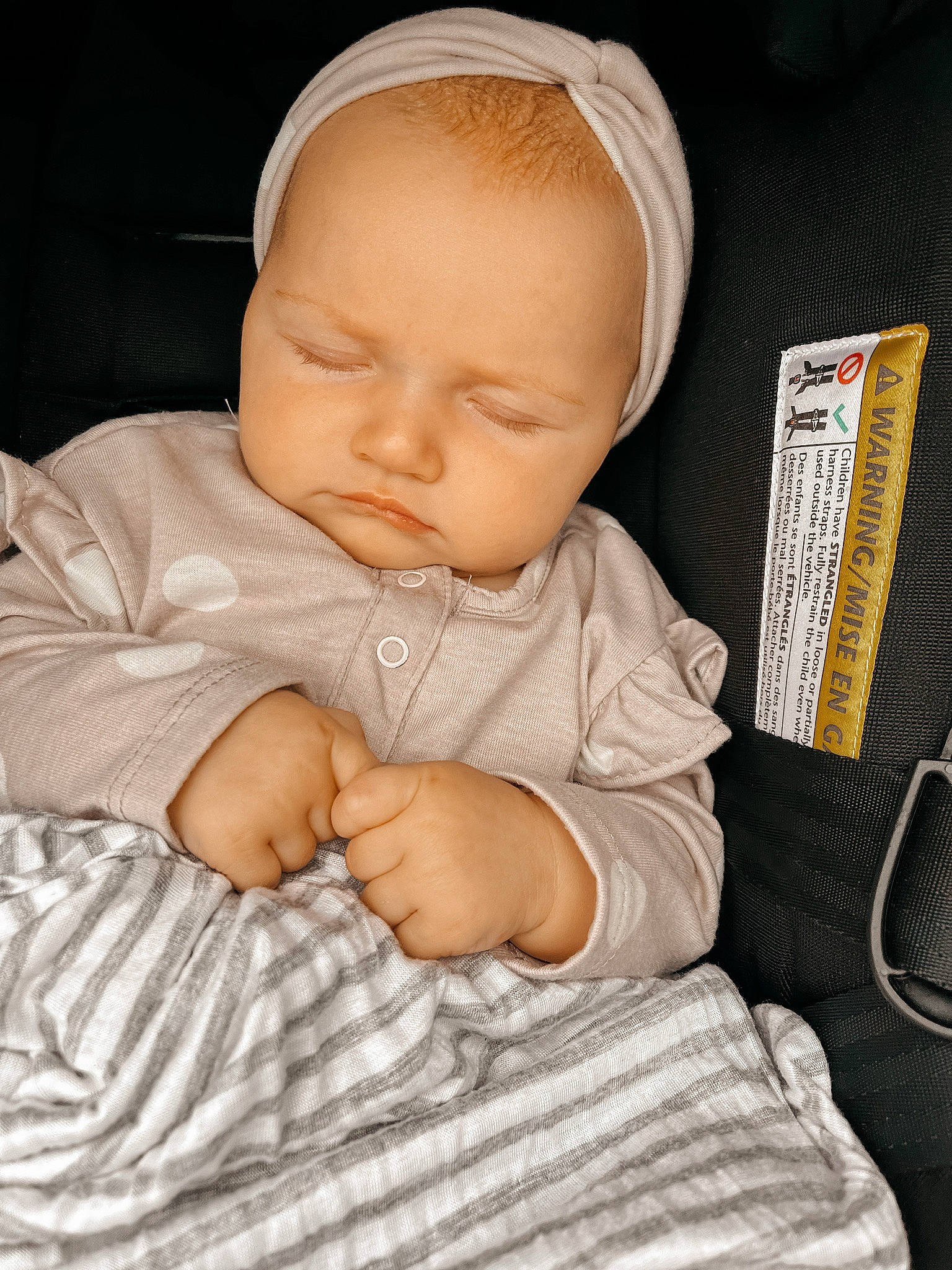 Evie is registered to the contest to win money with this photo: baby, baby_products, baby_sleeping, baby_toddler_clothing, cap, cheek, comfort, eye, finger, hand, headgear, human_body, linens, nose, person, sitting, skin, sleeve, textile, thumb