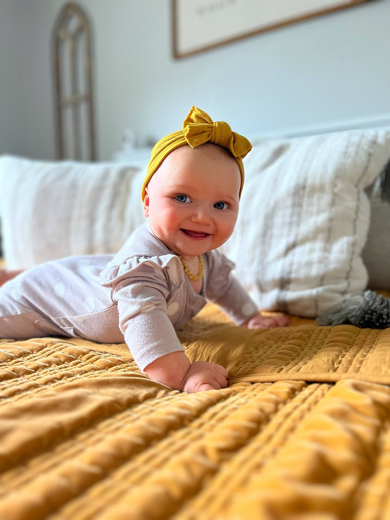 Evie is registered to the contest to win money with this photo: baby_toddler_clothing, bedding, child, comfort, eye, flash_photography, floor, flooring, fun, happy, hardwood, joy, linens, person, room, sitting, skin, sleeve, smile, toddler