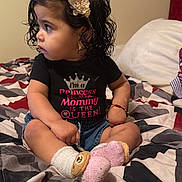 Estefani joined the competition — help win amazing prizes! bedroom, bedspread, black_shirt, bracelet, child, cross_legged, curly_hair, cute, earrings, expression, girl, headband, indoor, pink, portrait, shirt, sitting, socks, text_on_clothing, toddler