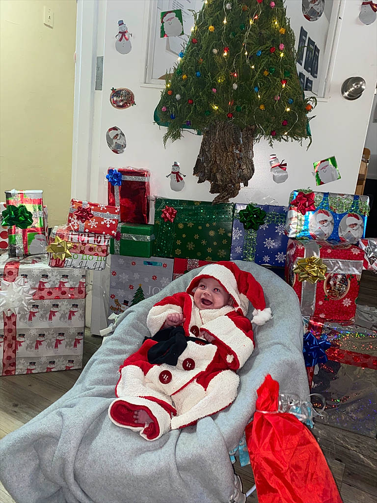 Zaylee is registered to the contest to win money with this photo: blue, christmas, christmas_decoration, christmas_eve, christmas_ornament, christmas_tree, decoration, event, green, headwear, holiday, holiday_ornament, interior_design, ornament, person, photograph, plant, red, sleeve, tree