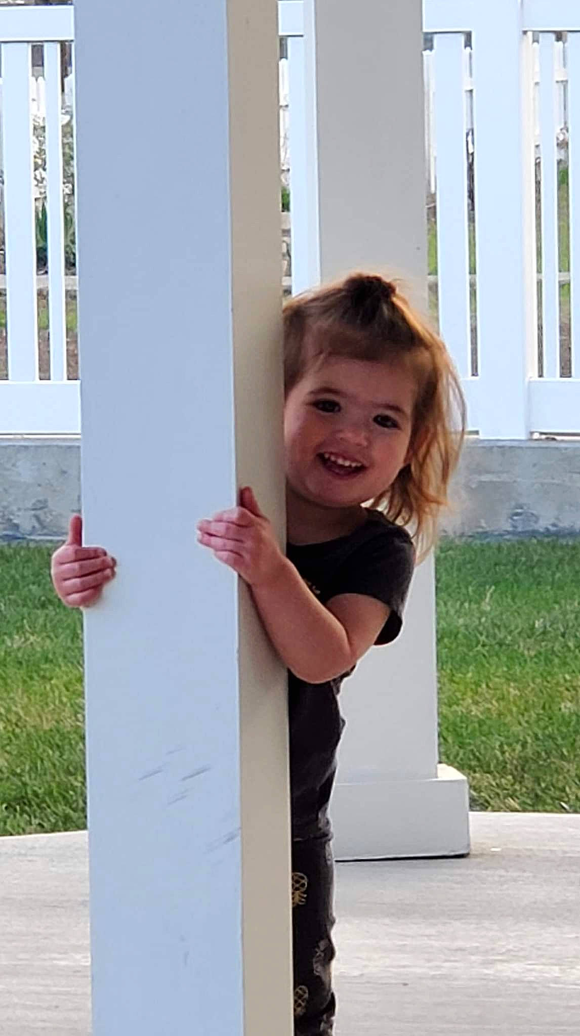 Skylie is registered to the contest to win money with this photo: blond, child, concrete, dress, fun, grass, hairstyle, happy, joy, leisure, magenta, person, plant, play, recreation, sitting, smile, t_shirt, toddler, vacation