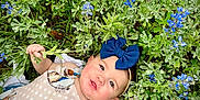 Azalea joined the competition — help win amazing prizes! baby, child, blue_bow, headband, flowers, greenery, outdoor, nature, plants, foliage, grass, cute, infant, smiling, happy, skin, hand, dress, lying_down, spring