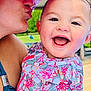 baby, child, adult, kiss, hat, smile, happy, outdoor, sunny, colorful_clothing, floral_pattern, close_up, person, holding, face, skin, portrait, joy, affection, family