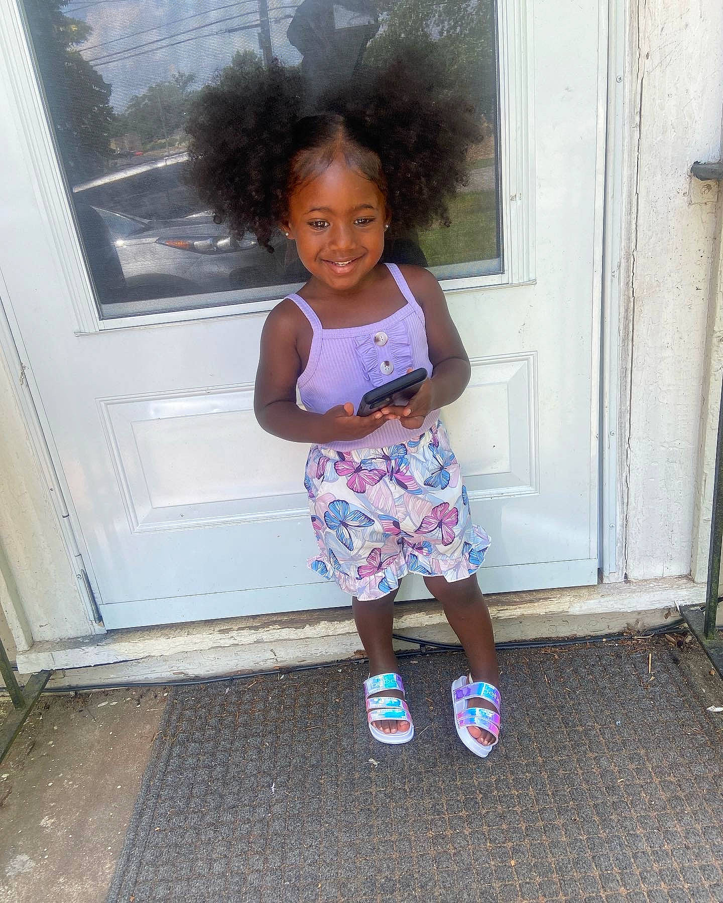 Amari joined the competition — help win amazing prizes! baby_toddler_clothing, child, door, electric_blue, face, fun, happy, human_leg, joy, magenta, pattern, person, pink, sleeve, smile, standing, thigh, tints_and_shades, toddler, vacation