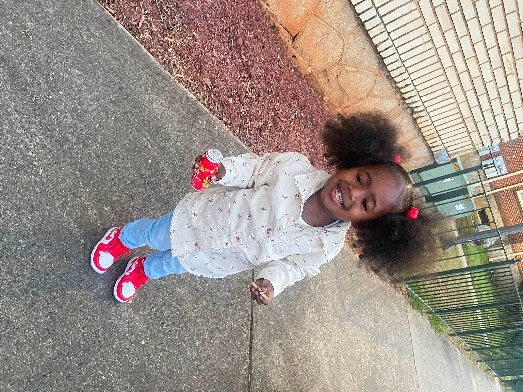 Amari is registered to the contest to win money with this photo: asphalt, carmine, child, city, concrete, denim, flooring, fun, jeans, joy, leisure, pattern, pedestrian, person, public_space, road_surface, shadow, sidewalk, textile, toddler