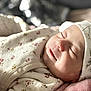 baby, newborn, sleeping, blanket, hat, floral, soft, cozy, closeup, face, infant, peaceful, cute, clothing, portrait, resting, indoors, warm, comfort, skin