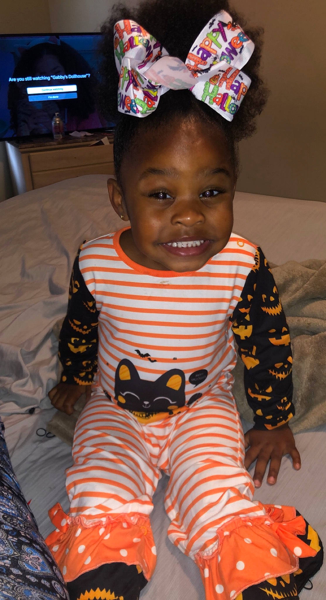 Amarah is registered to the contest to win money with this photo: baby, baby_toddler_clothing, cap, child, eye, facial_expression, fun, happy, head, joy, pattern, people, person, room, skin, sleeve, smile, t_shirt, television, textile