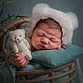Lyam participe au concours pour gagner de l'argent avec cette photo : baby, bed, blanket, bodypart, bonnet, clothing, face, finger, furniture, hand, happy, hat, head, newborn, person, photography, portrait, sleeping, teddybear, toy