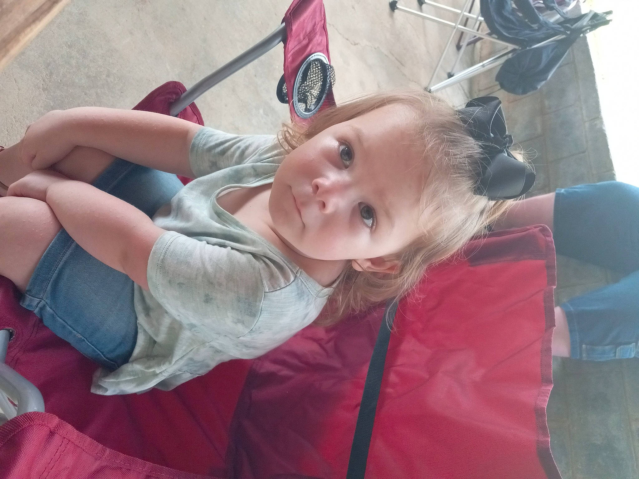 Armani is registered to the contest to win money with this photo: baby, child, comfort, event, foot, fun, gesture, grass, hairstyle, happy, human_leg, leisure, magenta, mouth, person, recreation, sitting, toddler, tree, vacation