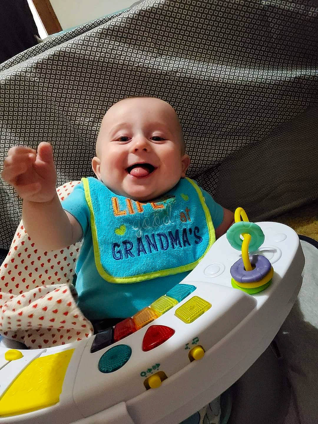 Evander joined the competition — help win amazing prizes! baby, baby_laughing, baby_products, baby_safety, baby_toddler_clothing, bib, child, comfort, couch, headwear, nose, person, polka_dot, product, toddler, tongue