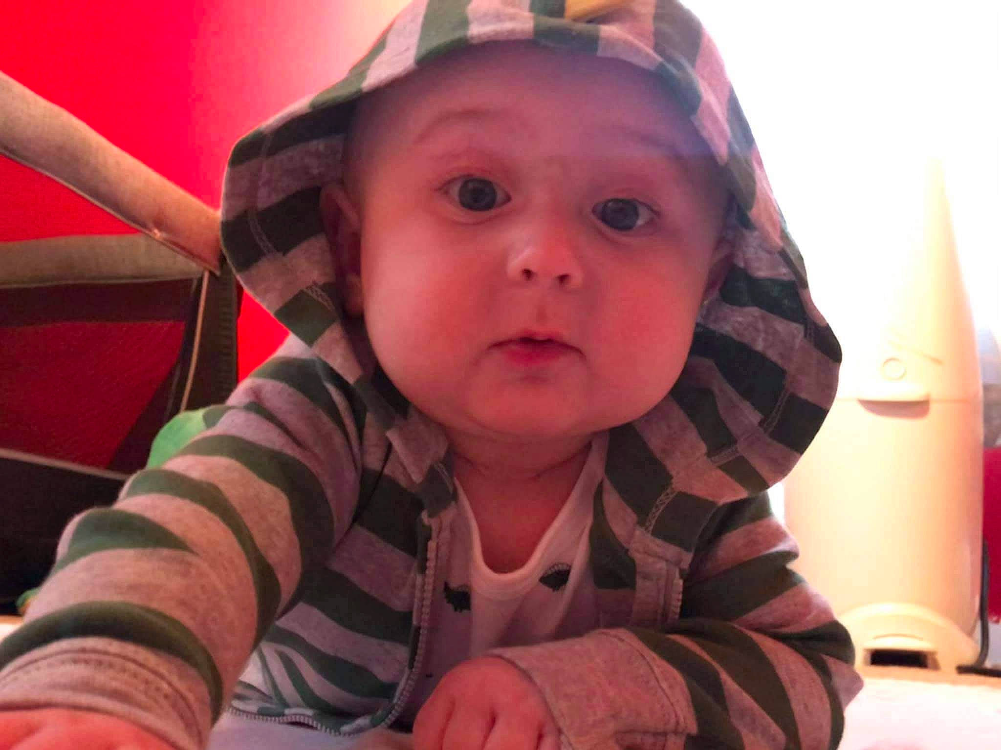 Evander is registered to the contest to win money with this photo: baby, baby_toddler_clothing, cheek, child, headwear, lamp, nose, person, pink, skin, surprise, sweater, toddler