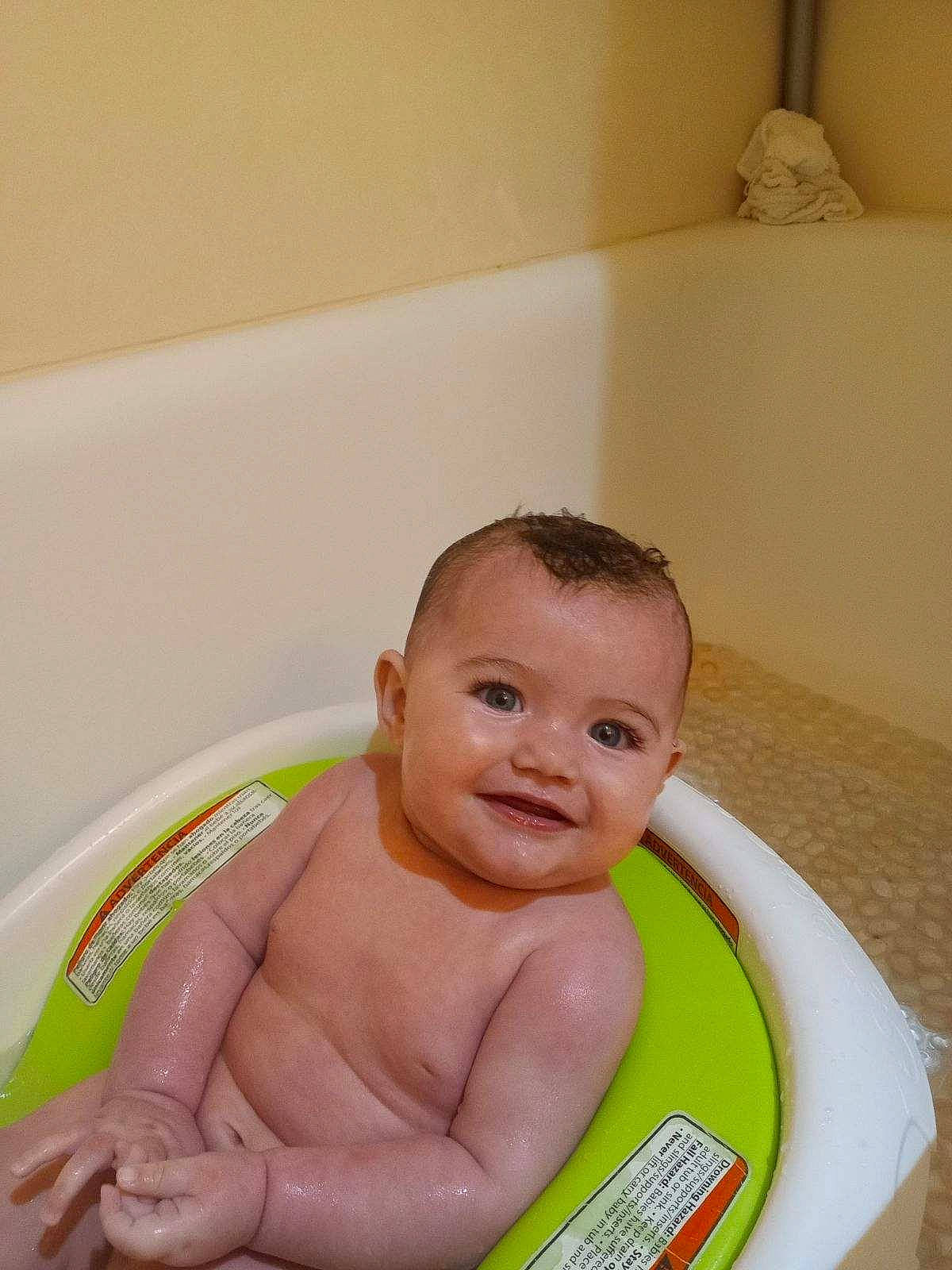 Toni is registered to the contest to win money with this photo: baby, baby_bathing, baby_products, bathing, bathroom, bathtub, chest, child, eye, fluid, fun, happy, human_body, joy, leisure, person, plumbing, plumbing_fixture, smile, thumb