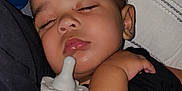 Kingston is registered to the contest to win money with this photo: baby, sleeping, pacifier, pillow, blanket, cuddle, face, infant, child, rest, comfort, closeup, indoors, soft, peaceful, cute, skin, hand, black_clothing, fabric