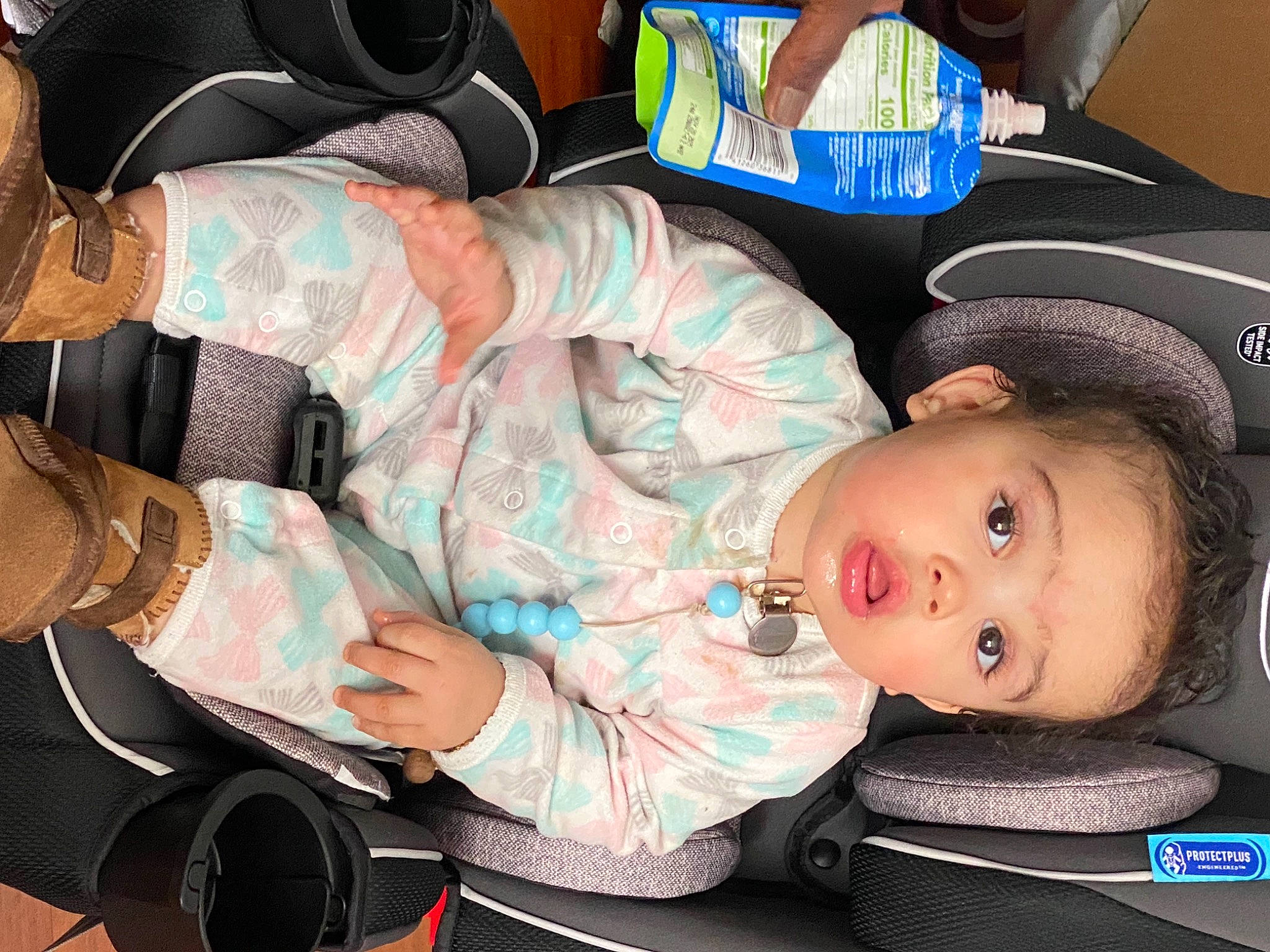 Emeri is registered to the contest to win money with this photo: auto_part, baby, baby_carriage, baby_in_car_seat, baby_products, baby_toddler_clothing, bag, car_seat, cheek, child, comfort, fun, lap, mouth, nail, pattern, person, sitting, surprise, thigh