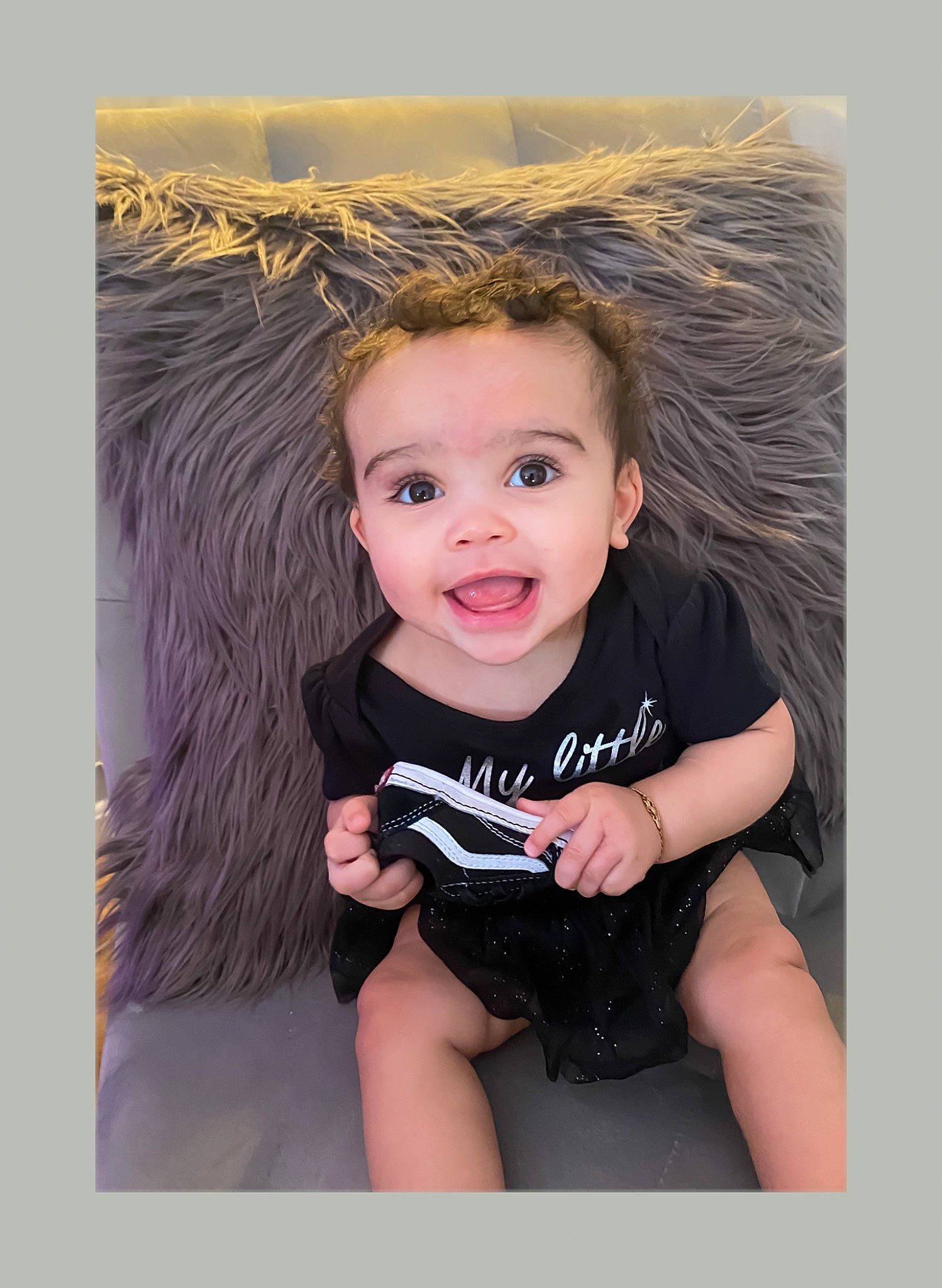 Emeri is registered to the contest to win money with this photo: arm, baby, baby_toddler_clothing, child, eye, finger, flash_photography, fun, happy, iris, knee, neck, person, shorts, sitting, skin, sleeve, smile, t_shirt, thigh