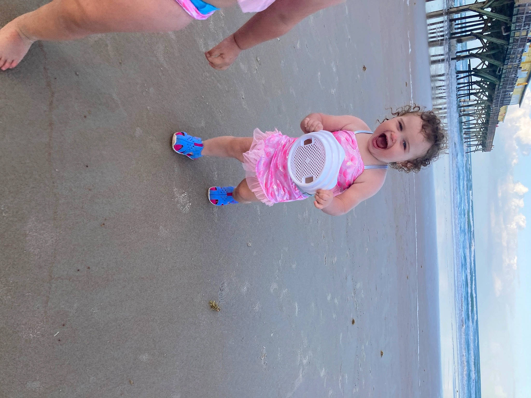 Hayden is registered to the contest to win money with this photo: baby, baby_toddler_clothing, barefoot, blue, child, foot, fun, happy, human_leg, leisure, person, pink, recreation, sand, shorts, summer, thigh, toddler, toe, water