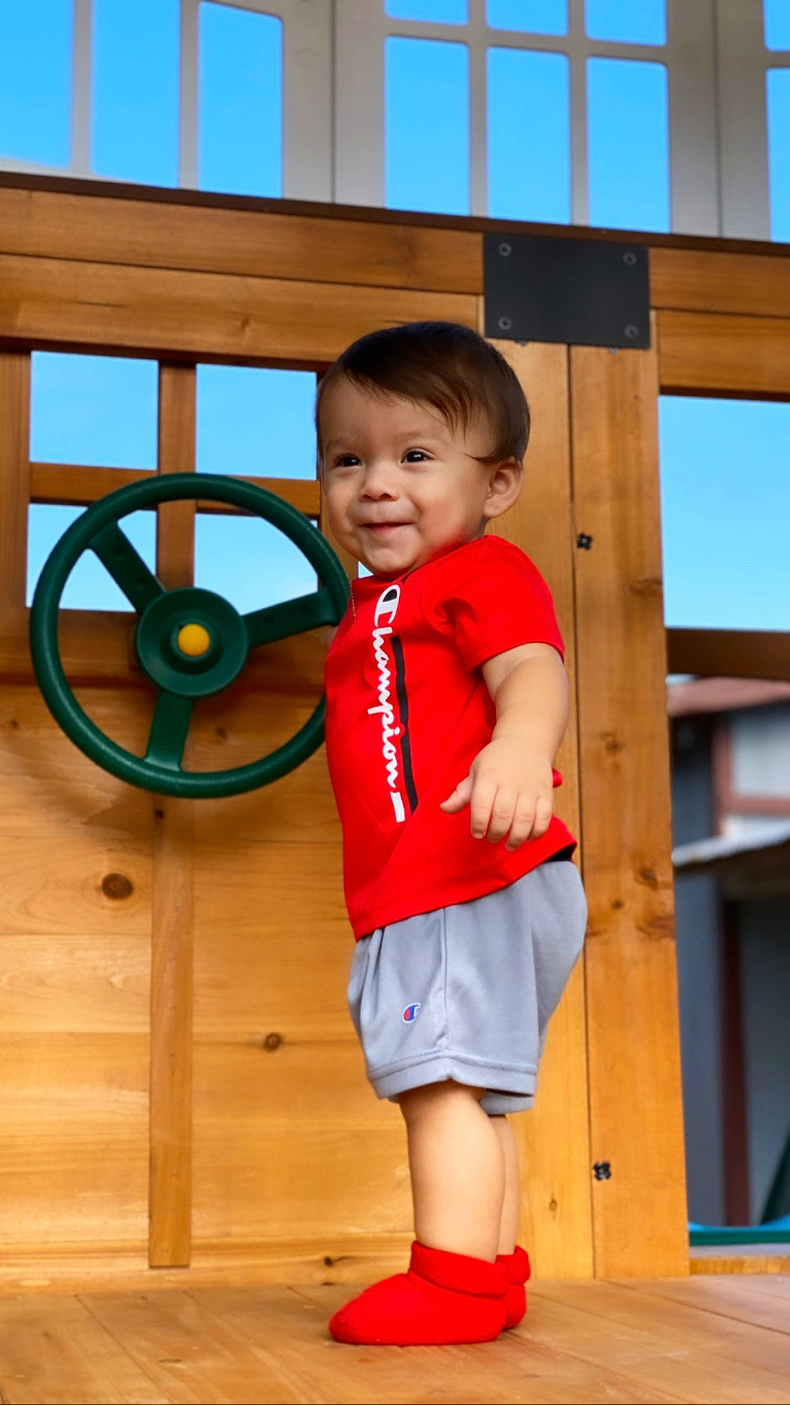 Tristian joined the competition — help win amazing prizes! child, child_model, human_settlement, leg, leisure, outdoor_play_equipment, person, play, playground, public_space, recreation, red, shorts, smile, standing, toddler, trunk