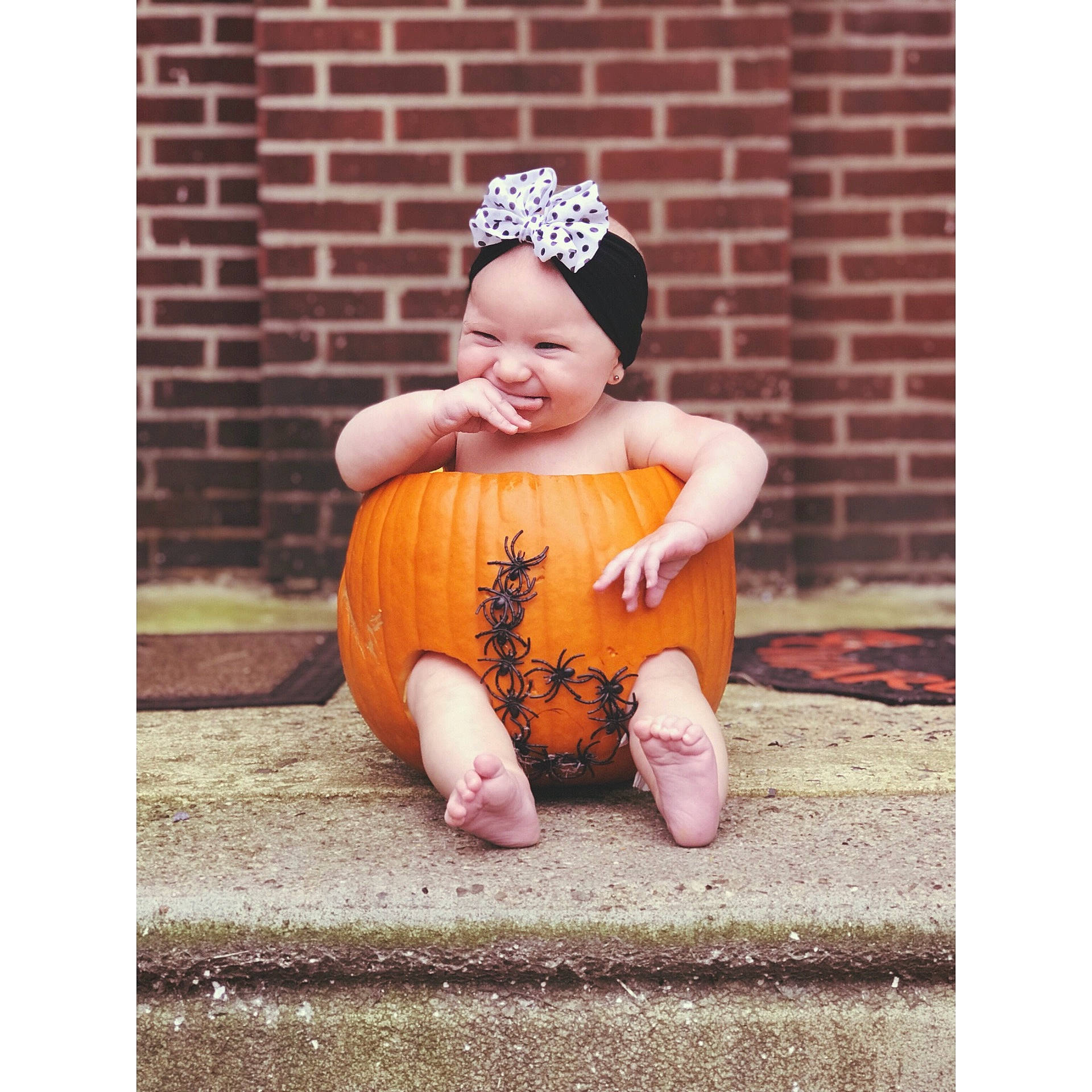 Gianna is registered to the contest to win money with this photo: child, hair_accessory, headgear, headpiece, infant, joy, orange, pattern, person, sitting, toddler