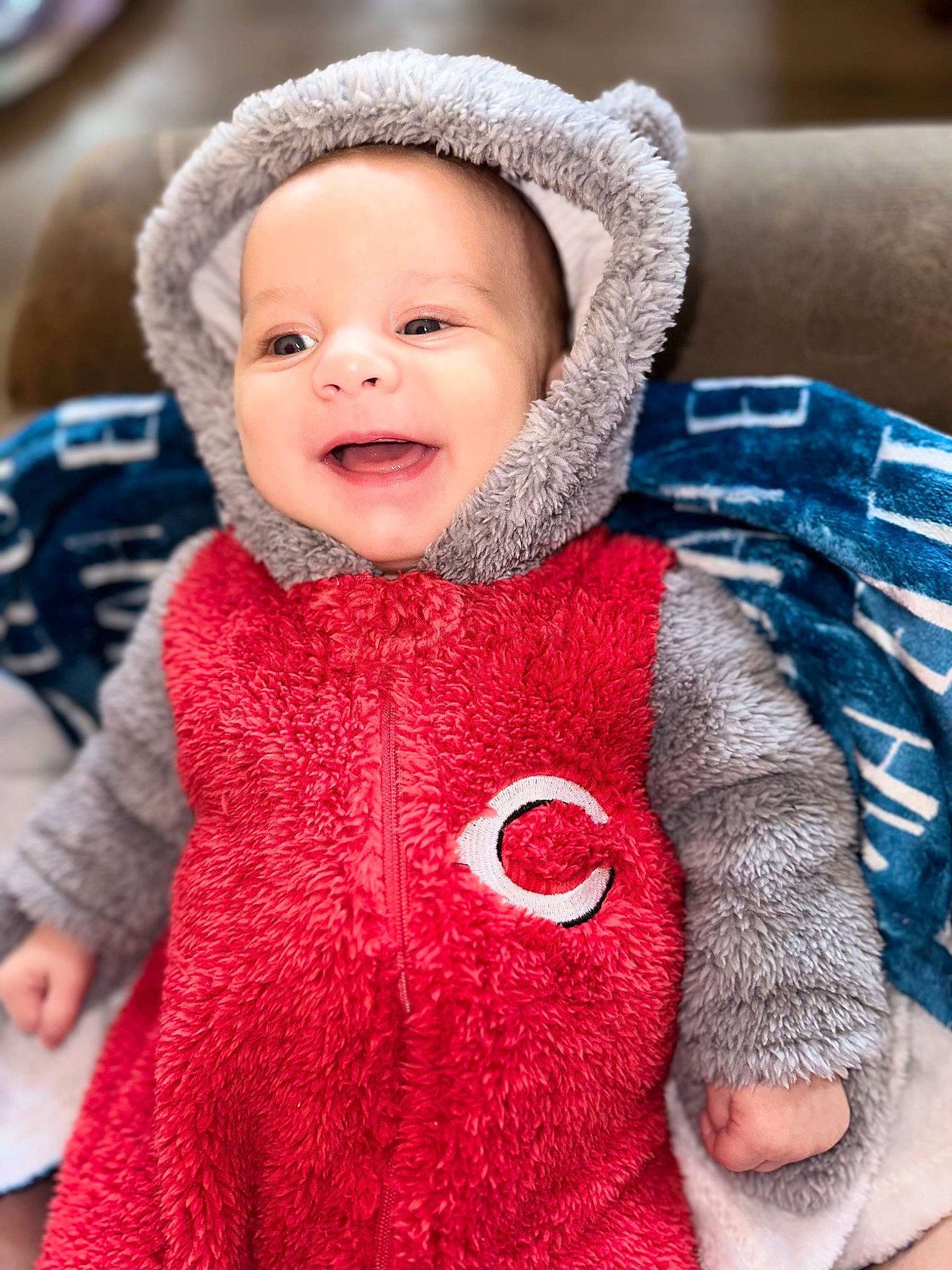 Elijah is registered to the contest to win money with this photo: baby, baby_toddler_clothing, cap, cheek, collar, electric_blue, eye, face, fur, happy, human_body, jacket, knit_cap, outerwear, pattern, person, skin, sleeve, smile, textile