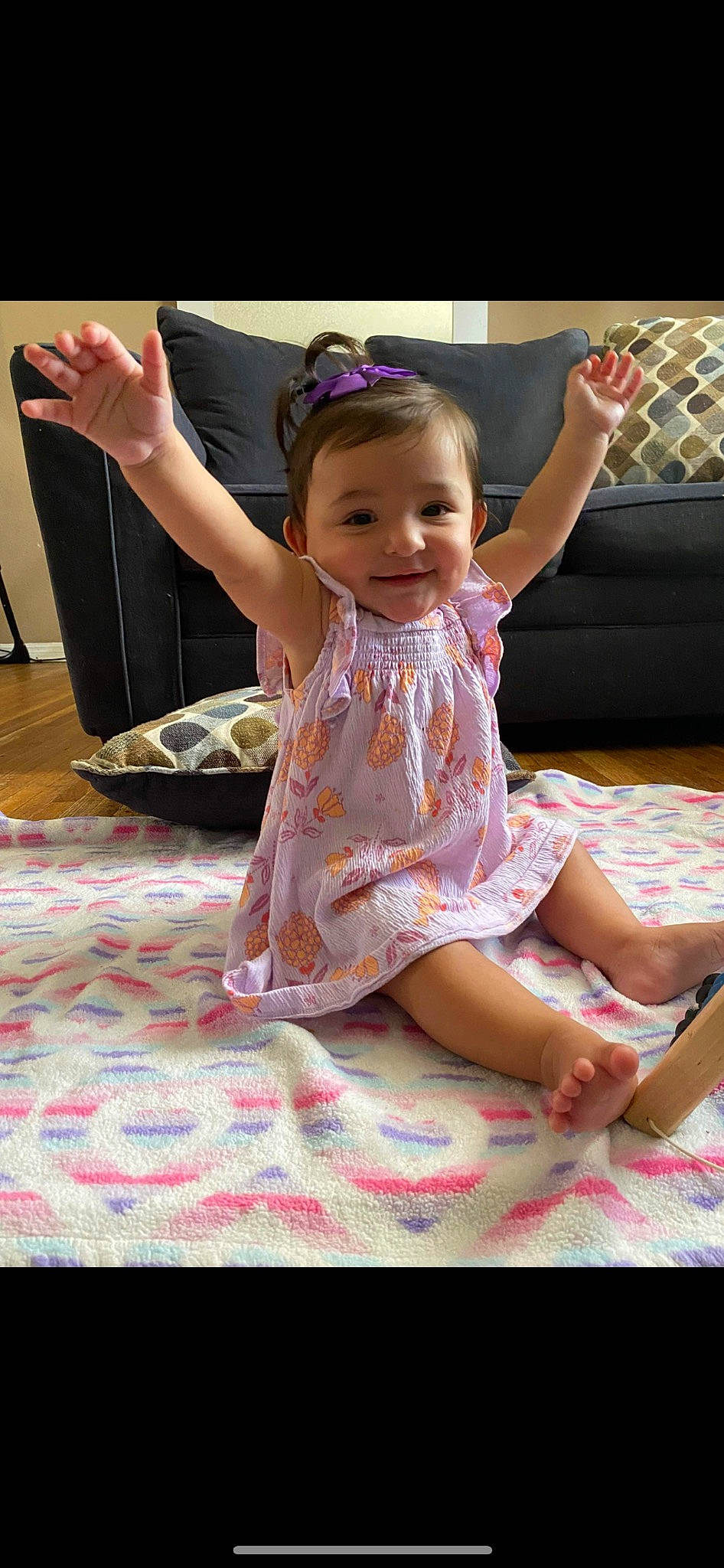 Sofia is registered to the contest to win money with this photo: baby, baby_toddler_clothing, child, dress, finger, floor, flooring, foot, fun, happy, human_leg, joy, leg, magenta, person, pink, purple, skin, smile, textile