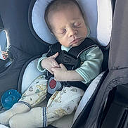 Grayson is registered to the contest to win money with this photo: baby, car_seat, infant, sleeping, pajamas, pacifier, clothing, safety_harness, child, newborn, cute, hands, face, head, seatbelt, car_interior, soft_lighting, peaceful, cozy, resting