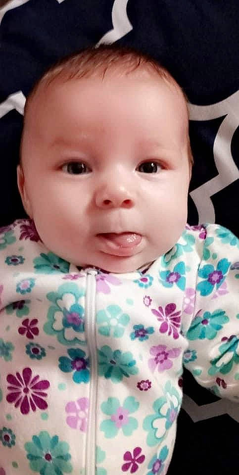 Stori is registered to the contest to win money with this photo: baby, baby_toddler_clothing, cheek, child, chin, collar, eyebrow, eyelash, facial_expression, iris, linens, lip, neck, nose, pattern, person, pink, skin, sleeve, t_shirt