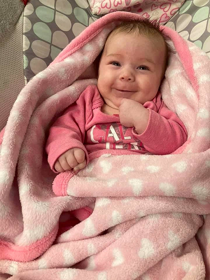 Stori is registered to the contest to win money with this photo: arm, baby, baby_toddler_clothing, cheek, comfort, eyebrow, eyelash, face, hair, hand, head, human_body, joy, lip, mouth, neck, nose, person, product, skin