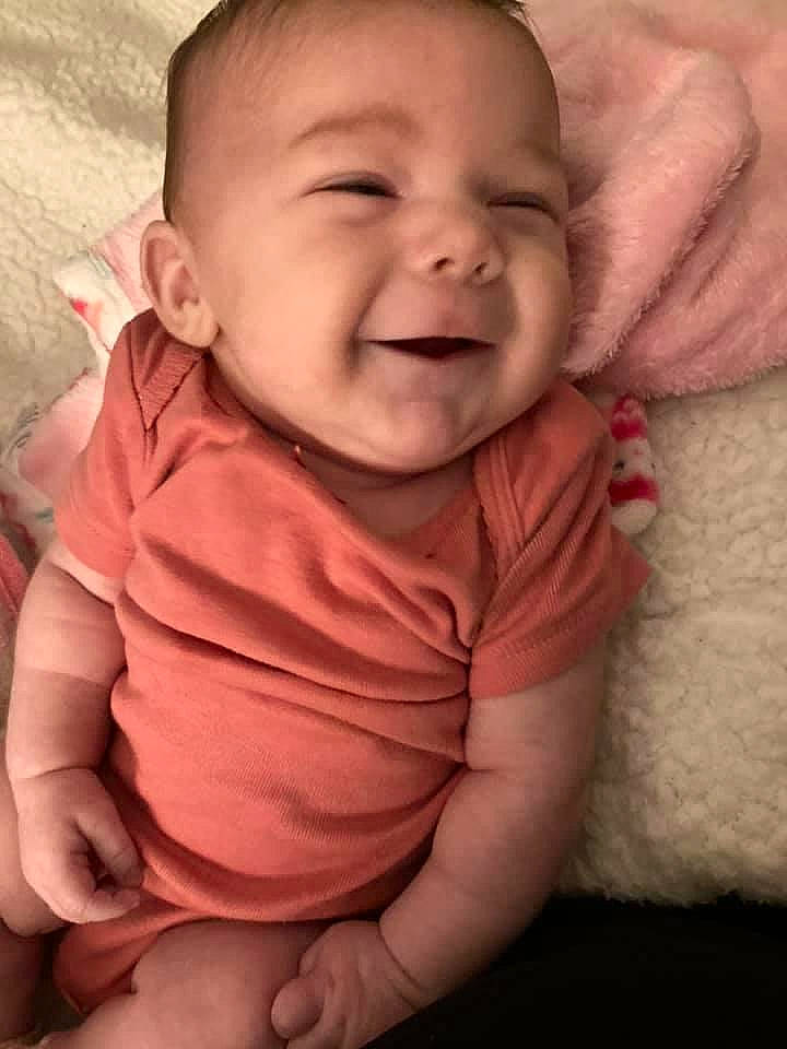 Stori is registered to the contest to win money with this photo: baby, baby_toddler_clothing, cheek, chin, comfort, eye, finger, gesture, hand, happy, human_body, iris, lip, mouth, neck, nose, person, pink, skin, sleeve