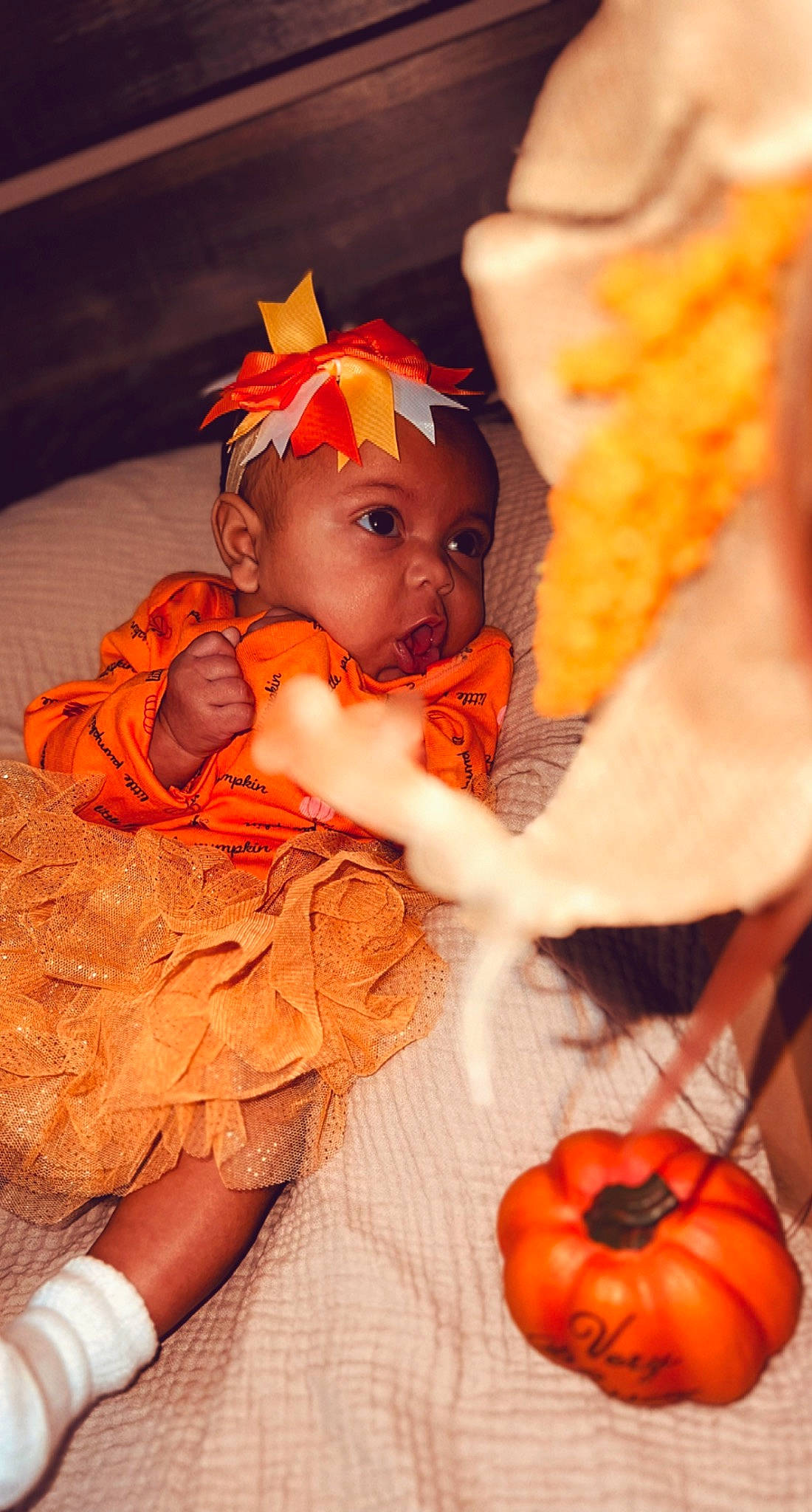 Gia is registered to the contest to win money with this photo: baby, baby_toddler_clothing, calabaza, child, cucurbita, event, eye, fruit, gourd, happy, headwear, human_body, natural_foods, orange, peach, person, pumpkin, squash, toddler, tradition