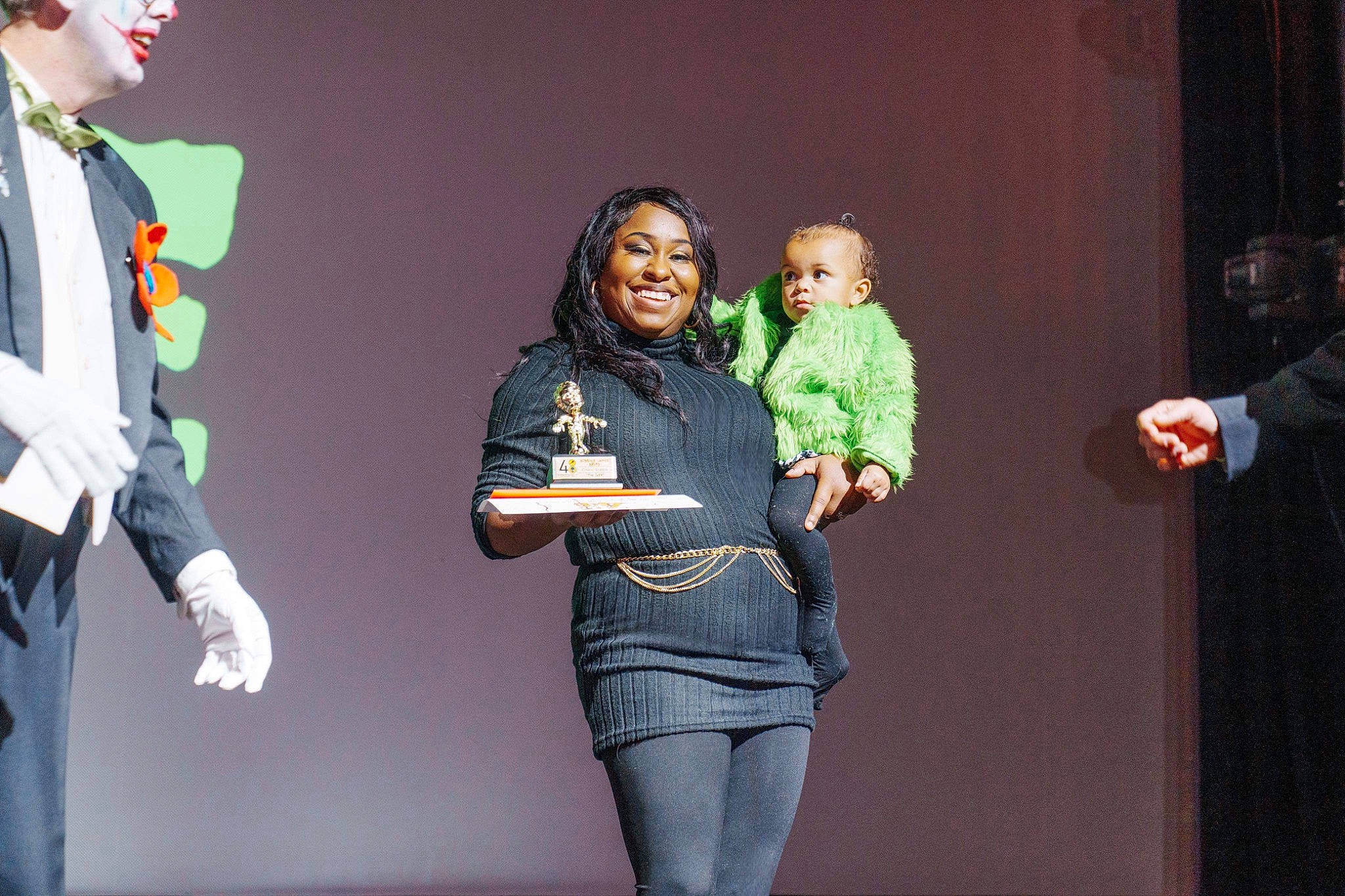 Gia joined the competition — help win amazing prizes! boot, community, conversation, costume, entertainment, event, fashion_design, fun, gesture, joy, outerwear, performance, performing_arts, person, public_event, social_group, standing, t_shirt, thigh, tie