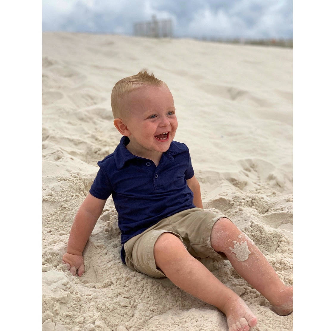 Briggs is registered to the contest to win money with this photo: baby, beach, beige, child, fun, joy, leg, person, photo_shoot, photograph, photography, play, portrait_photography, sand, shorts, sitting, sleeve, stock_photography, summer, t_shirt