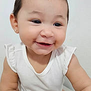 Sophia joined the competition — help win amazing prizes! baby, child, smiling, crawling, white_clothing, onesie, infant, happy, cute, portrait, face, skin, short_hair, indoor, light_background, young_child, person, baby_girl, close_up, small_hands