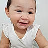 baby, child, smiling, crawling, white_clothing, onesie, infant, happy, cute, portrait, face, skin, short_hair, indoor, light_background, young_child, person, baby_girl, close_up, small_hands