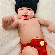 Dominic joined the competition — help win amazing prizes! baby, infant, hat, knitted_hat, bear_ears, red_shorts, knitted_shorts, blanket, white_blanket, child, cute, smiling, skin, lying_down, hand, portrait, indoors, cozy, soft_texture, playful