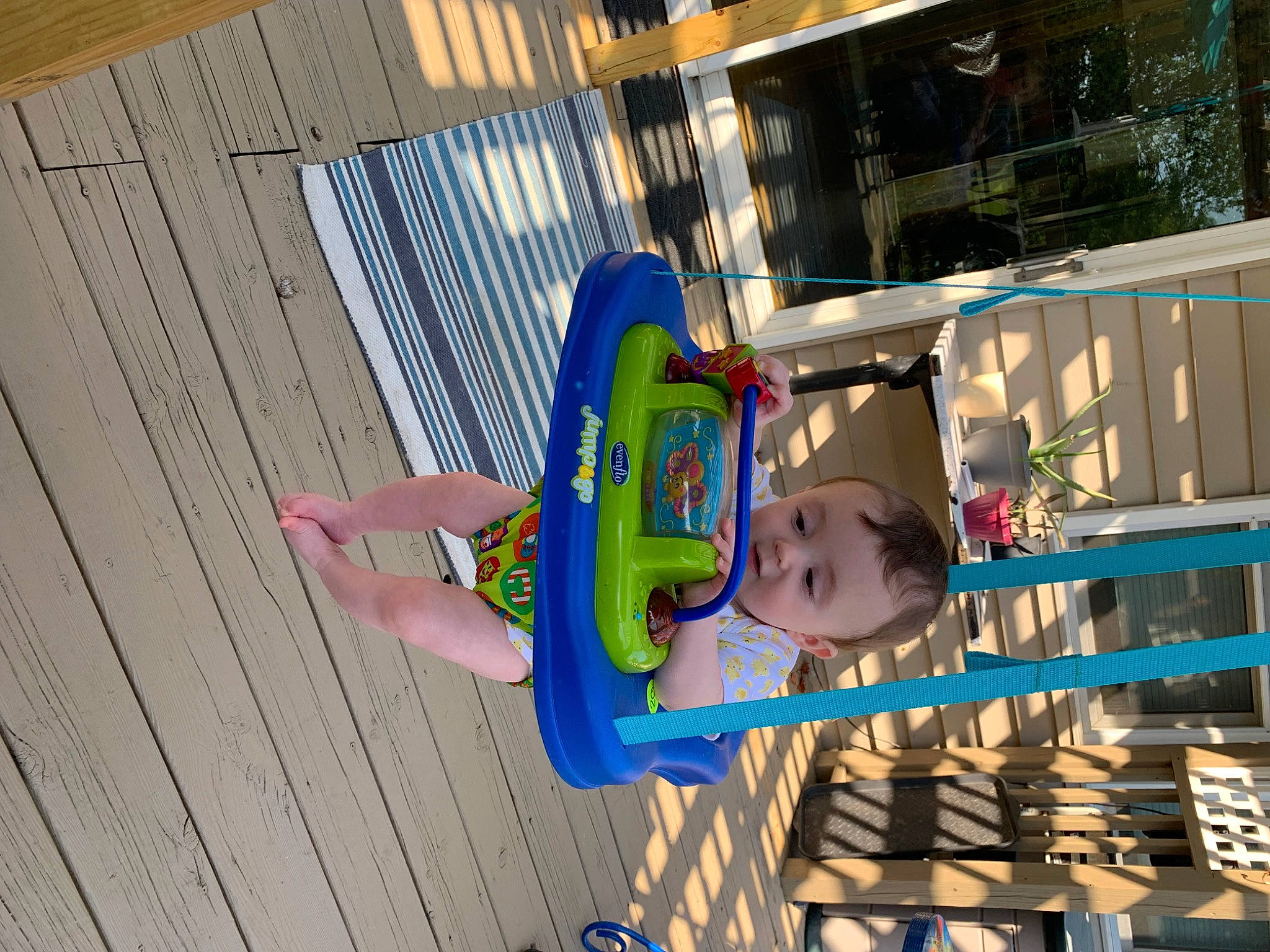 Justin is registered to the contest to win money with this photo: baby, baby_toddler_clothing, child, city, electric_blue, fun, happy, hat, house, leisure, magenta, outdoor_play_equipment, person, plant, play, recreation, toddler, tree, wood