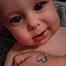baby, child, face, blue_eyes, hand, tattoo, heart, skin, close_up, expression, person, cute, indoor, infant, human, portrait, holding, love, toddler, chubby_cheeks