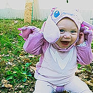 Freya Ray Smith joined the competition — help win amazing prizes! baby, child, costume, purple, smiling, outdoor, leaves, grass, playful, cute, happy, sitting, person, headwear, animal_costume, fall, nature, baby_clothes, fun, expression