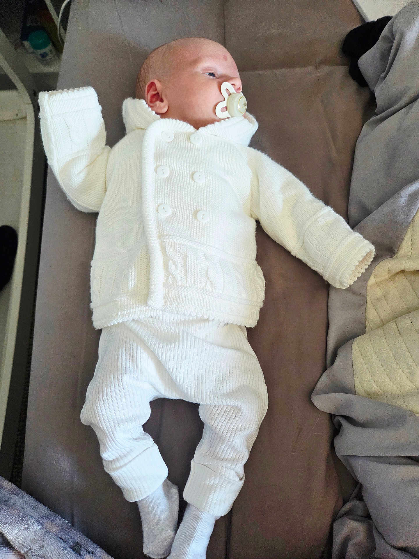 Kai joined the competition — help win amazing prizes! baby, infant, pacifier, white_clothing, knitted_sweater, pants, socks, bed, blanket, sleepwear, lying_down, indoors, resting, child, newborn, cute, peaceful, soft_fabric, portrait, young