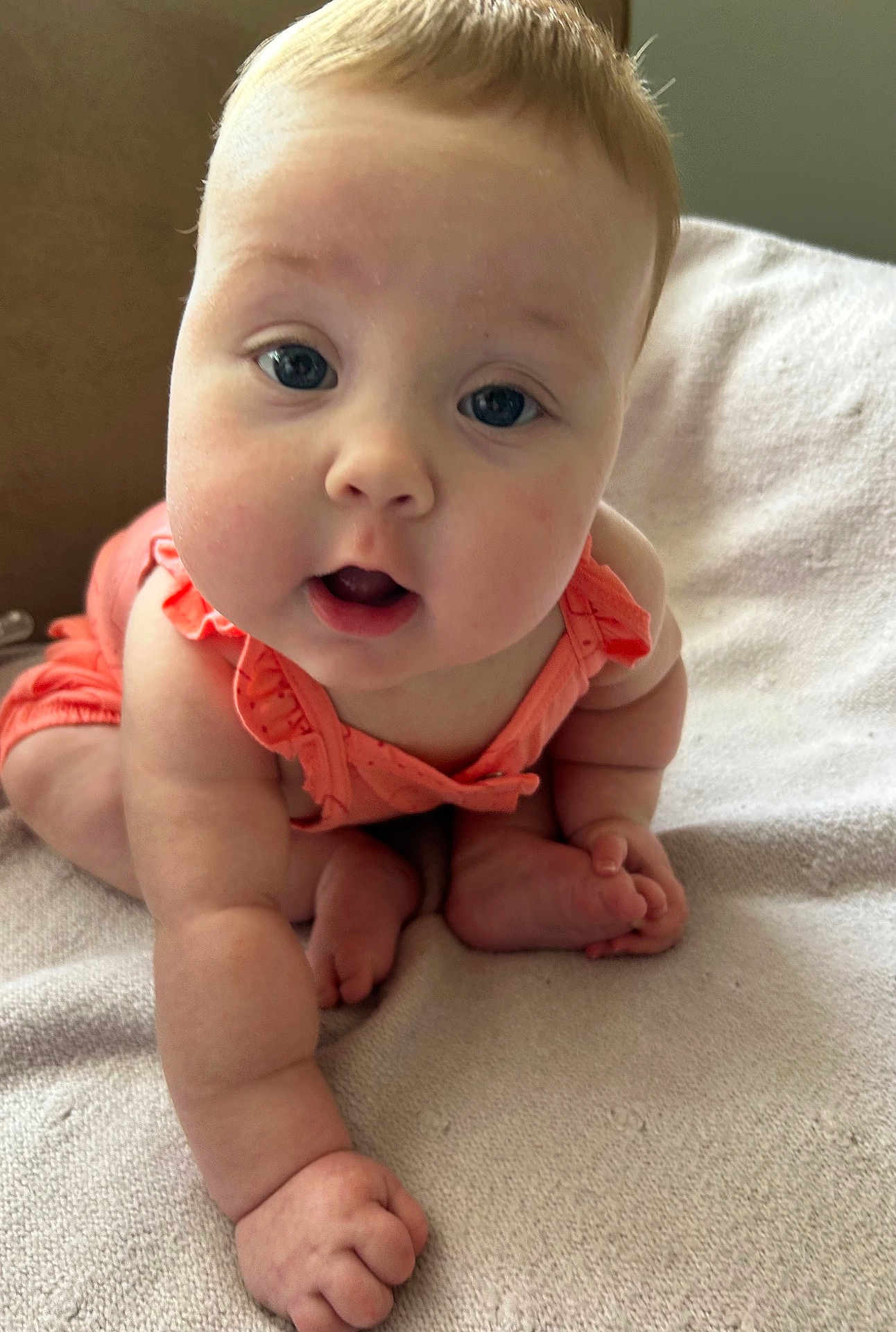 Isabella is registered to the contest to win money with this photo: baby, infant, crawling, closeup, face, skin, cheeks, eyes, mouth, hand, foot, fingers, toes, clothing, blanket, indoors, cute, child, person, expression