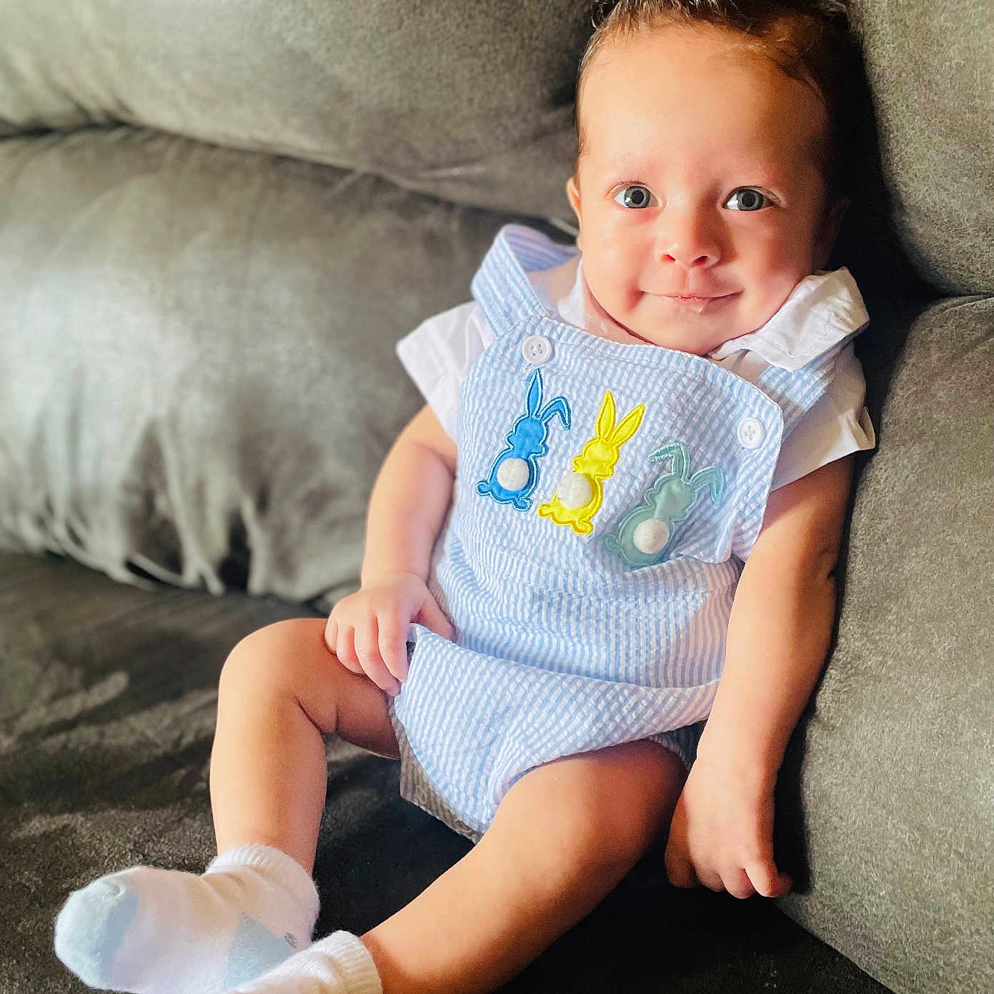 Jaxon is registered to the contest to win money with this photo: baby, clothing, couch, cushion, face, furniture, hair, happy, head, homedecor, hosiery, newborn, person, photography, pillow, portrait, sitting, sleeve, smile, sock