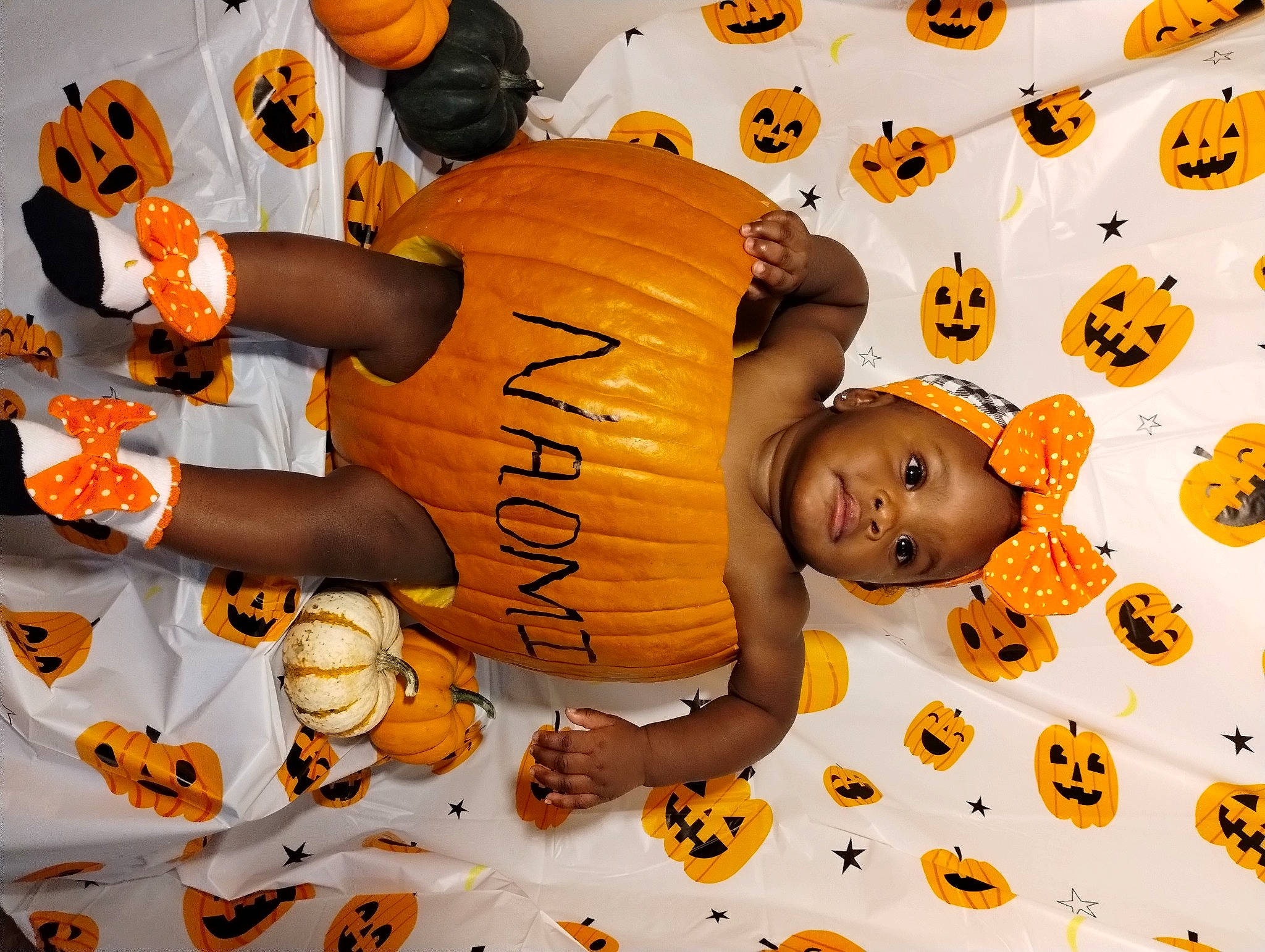 Naomi is registered to the contest to win money with this photo: art, baby, brown, calabaza, child, fun, happy, orange, pattern, person, pumpkin, room, toddler, yellow