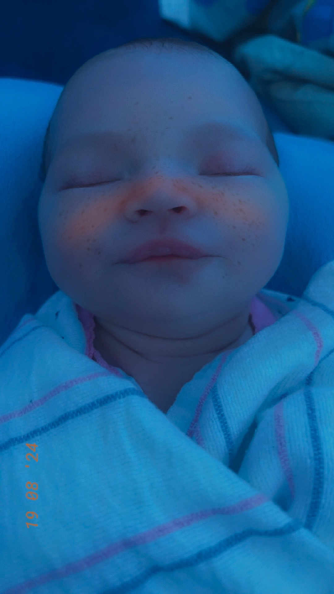 Delilah joined the competition — help win amazing prizes! baby, bed, blanket, bodypart, face, furniture, happy, head, mouth, newborn, person, photography, portrait, quilt, sleeping, smile, towel