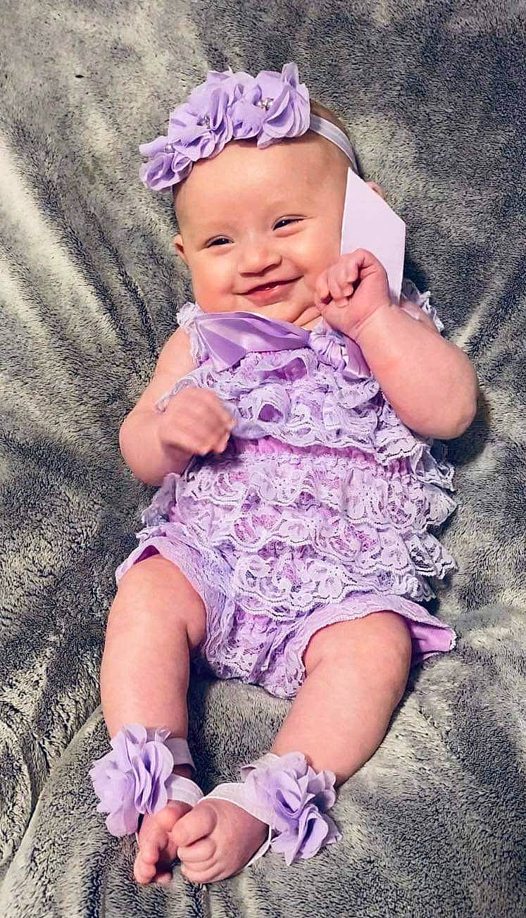 Jessica joined the competition — help win amazing prizes! baby, baby_toddler_clothing, child, dress, face, grass, happy, head, headband, headpiece, joy, magenta, pattern, person, pink, purple, skin, sleeve, smile, thigh