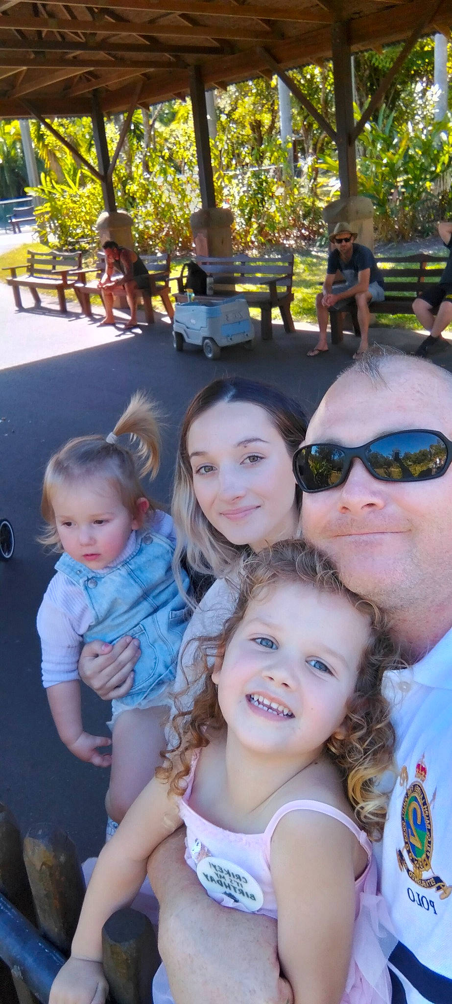 Alexis is registered to the contest to win money with this photo: community, facial_expression, fun, glasses, goggles, green, happy, joy, leisure, mammal, person, photograph, plant, product, public_space, smile, social_group, sunglasses, toddler, tree