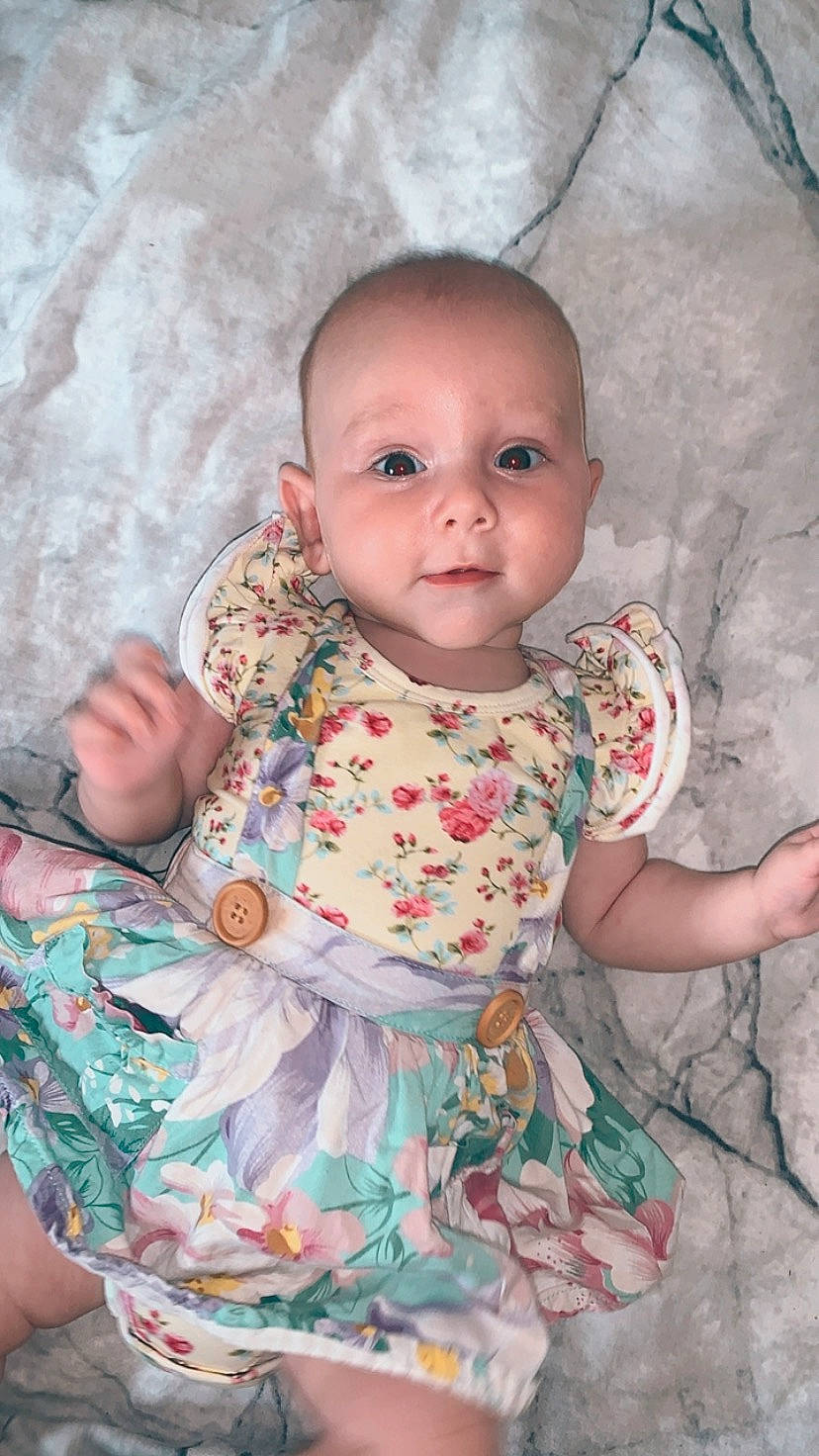 Esmae joined the competition — help win amazing prizes! baby, baby_toddler_clothing, cheek, child, chin, dress, eye, hairstyle, head, iris, linens, lip, mouth, nose, pattern, person, pink, skin, sleeve, textile